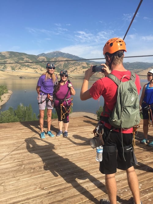 Zipline Utah guide taking a photo of two guests Zipline Utah guide taking a photo of two guests