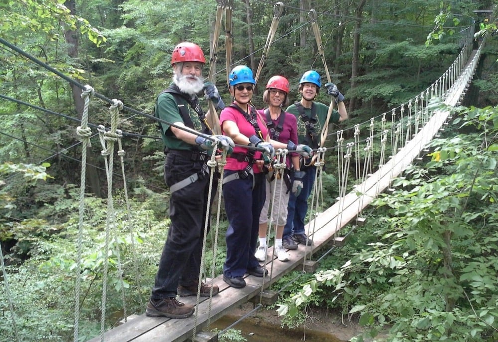 Four people on a suspension bridge
