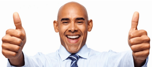 Smiling man in a shirt and tie with two thumbs up