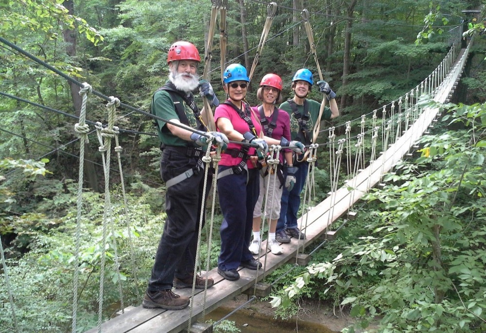 Four people on a suspension bridge