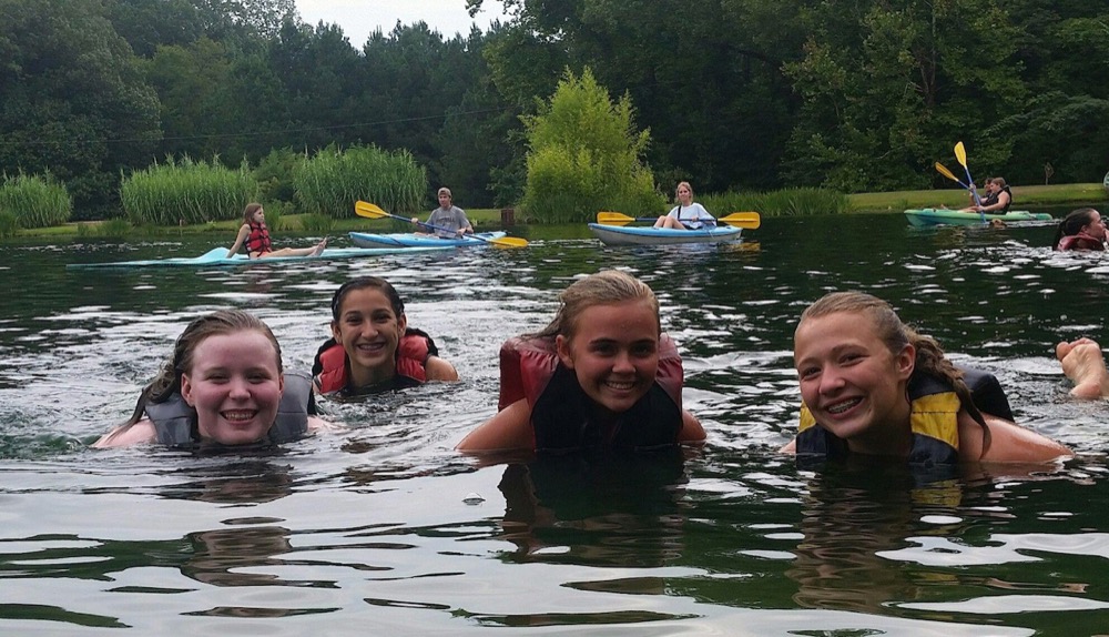 Youths swimming in a lake